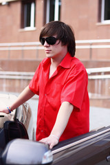 Young businessman sitting in a car.