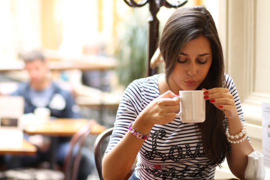 Beautiful Young Girl Sipping Coffee