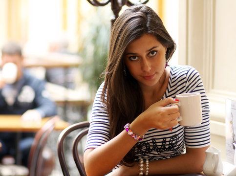 Beautiful Young Girl Sipping Coffee