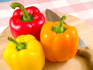Bell Peppers on a Wooden Cutting Board with Knife