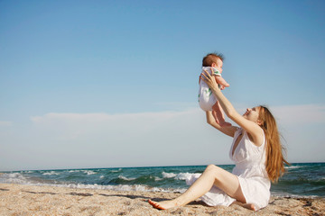 Fototapeta na wymiar happy mother and baby on beach