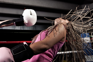 Blonde girl getting knocked out in a boxing ring - Powered by Adobe