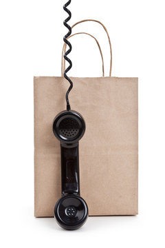 Brown paper shopping bag and telephone