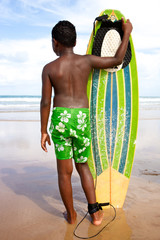 surfer boy teen going surfing surfboard at the beach