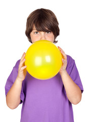 Funny boy blowing up a yellow balloon