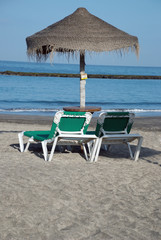Beach umbrella and two loungers. Canary Islands