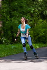 Fototapeta na wymiar Young woman rollerskating