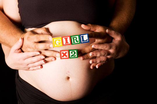 Pregnant couple holding wooden playing blocks