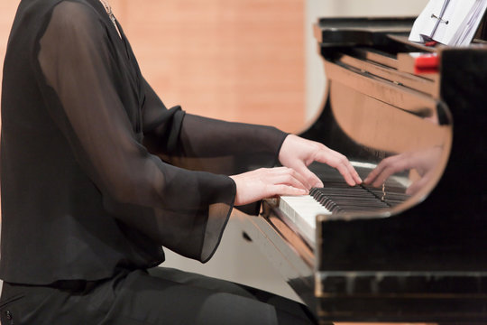 Hands of piano player during performance.