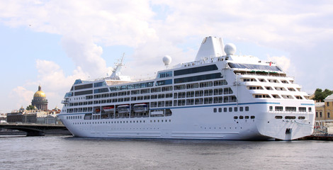 luxury white cruise ship shot at angle at water level