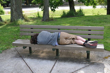 Sleeping on a bench in a public park