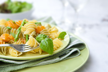 Colorful pasta with asparagus and rocket pesto and basil