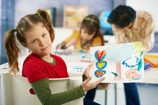 Elementary age children painting in classroom