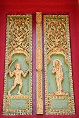 Fototapeta na wymiar buddhist art on window of temple, Wat Ku Ka Singh, Roi-Et