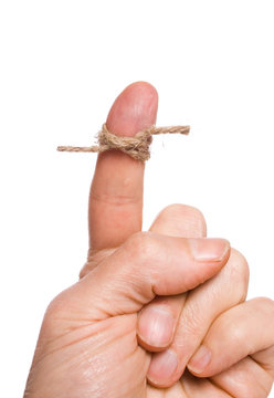A string tied around a finger to remind someone of something.