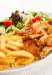 Grilled meat with fried potatoes and vegetables
