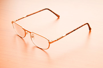 Reading glasses on the wooden table