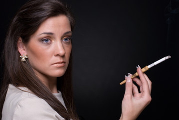 Obraz premium Close up portrait of smocking young fashion woman