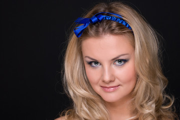 Closeup portrait of fashion woman with blue bow