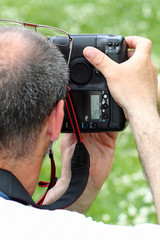 professional photographer with SLR from behind