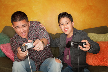 Hispanic Man and Boy Playing Video game