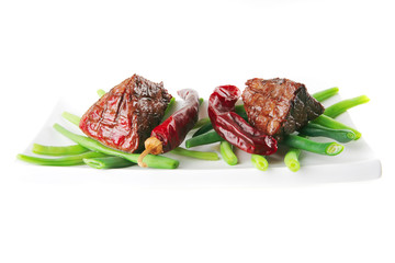 roast veal fillet on a plate with peppers