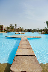 bridge to water. palms and sky
