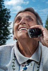 Happy Senior Woman Using Cordless Phone