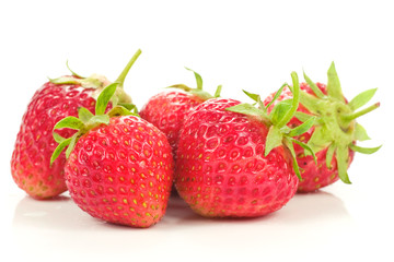 five red strawberries, isolated on white background