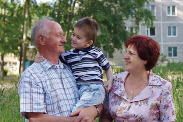 grandmother, grand-dad and grandchild on  nature