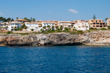 Fototapeta na wymiar Cala Anguila luxury villas and the shore, Majorca, Spain