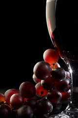 Red wine with grapes - 23709709