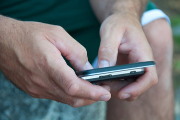 Hands of Man Texting on Smartphone
