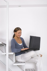 Woman working on laptop at home