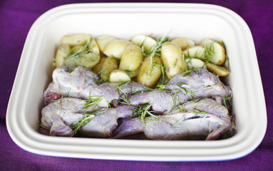 Raw quail with potatoes and rosemary ready for roasting