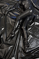 detail of lying woman in latex
