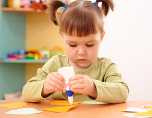 Little girl doing arts and crafts in preschool
