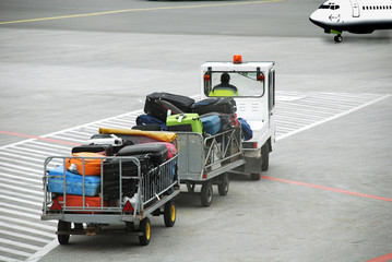 Airport.  Luggage traffic on an electromobile  to the plane