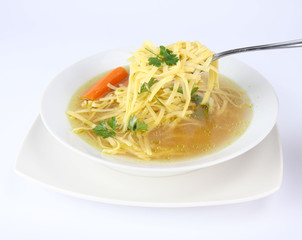 Chicken soup with macaroni - some of it on a spoon