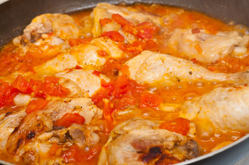 chicken baking in tomato and garlic sauce