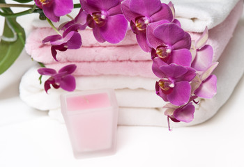 Aromatherapy still life with purple orchid, towels and candle
