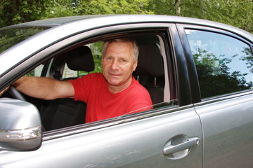 man after the helm of car
