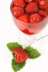 Jelly with strawberries decorated with a strawberry on a leaf