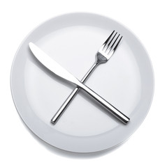 White empty plate with fork and knife