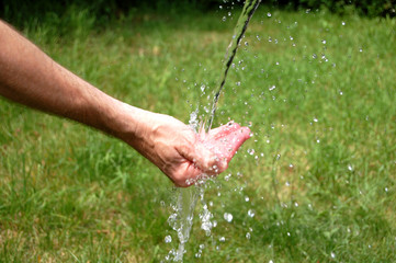 Water Washing Over Man's Hand