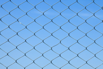 Detailed wire fence against blue sky