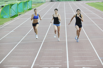 girls running on athletics race track