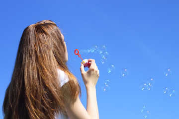 Girl blowing bubbles