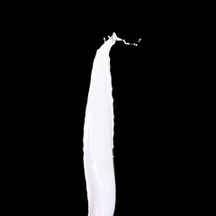 Fototapeta premium Splash of white milk over black background