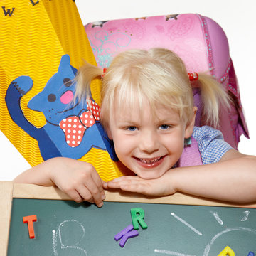 Cute blond child is happy to start of school